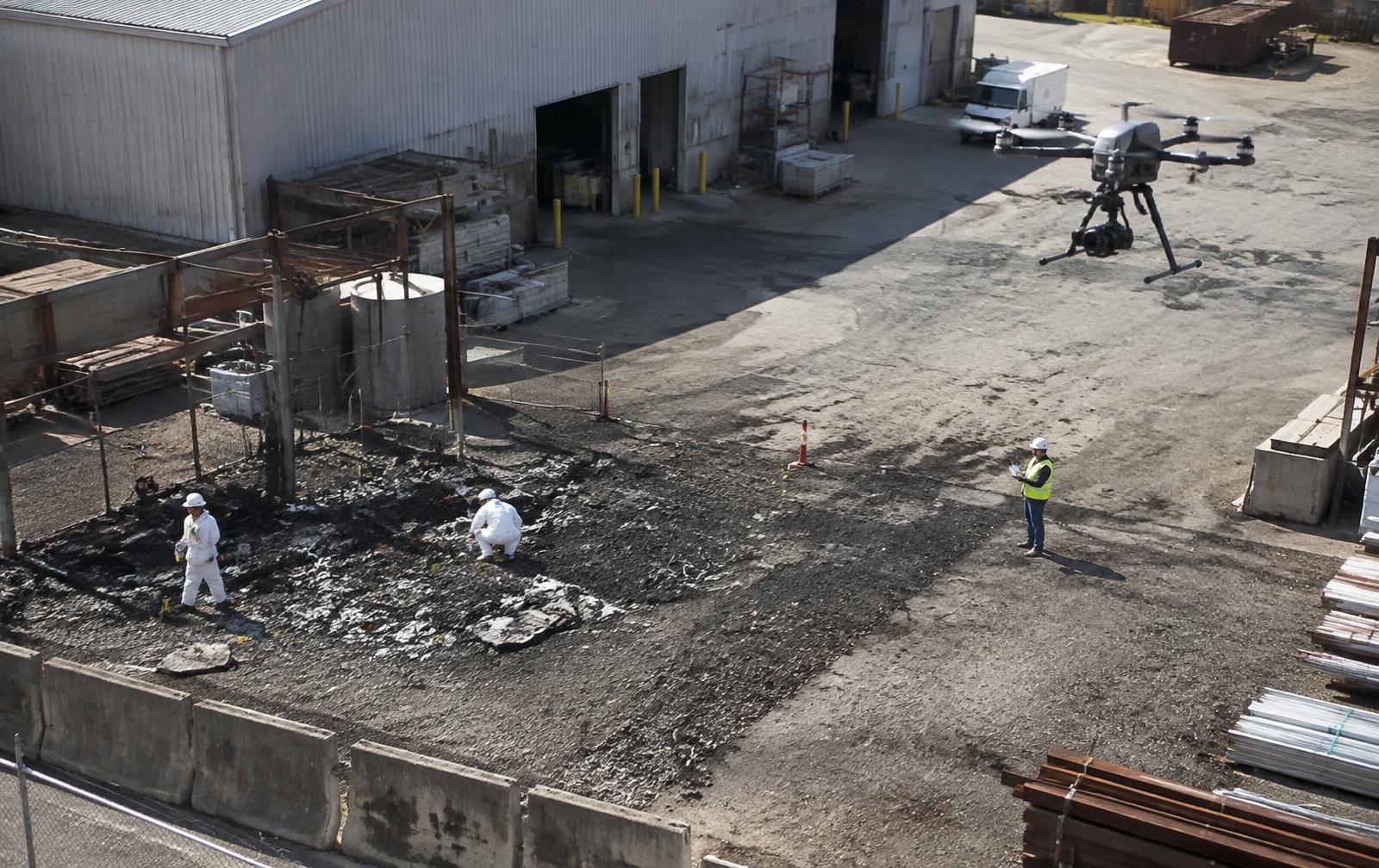 Drone and field team documenting an industrial incident scene for reconstruction
